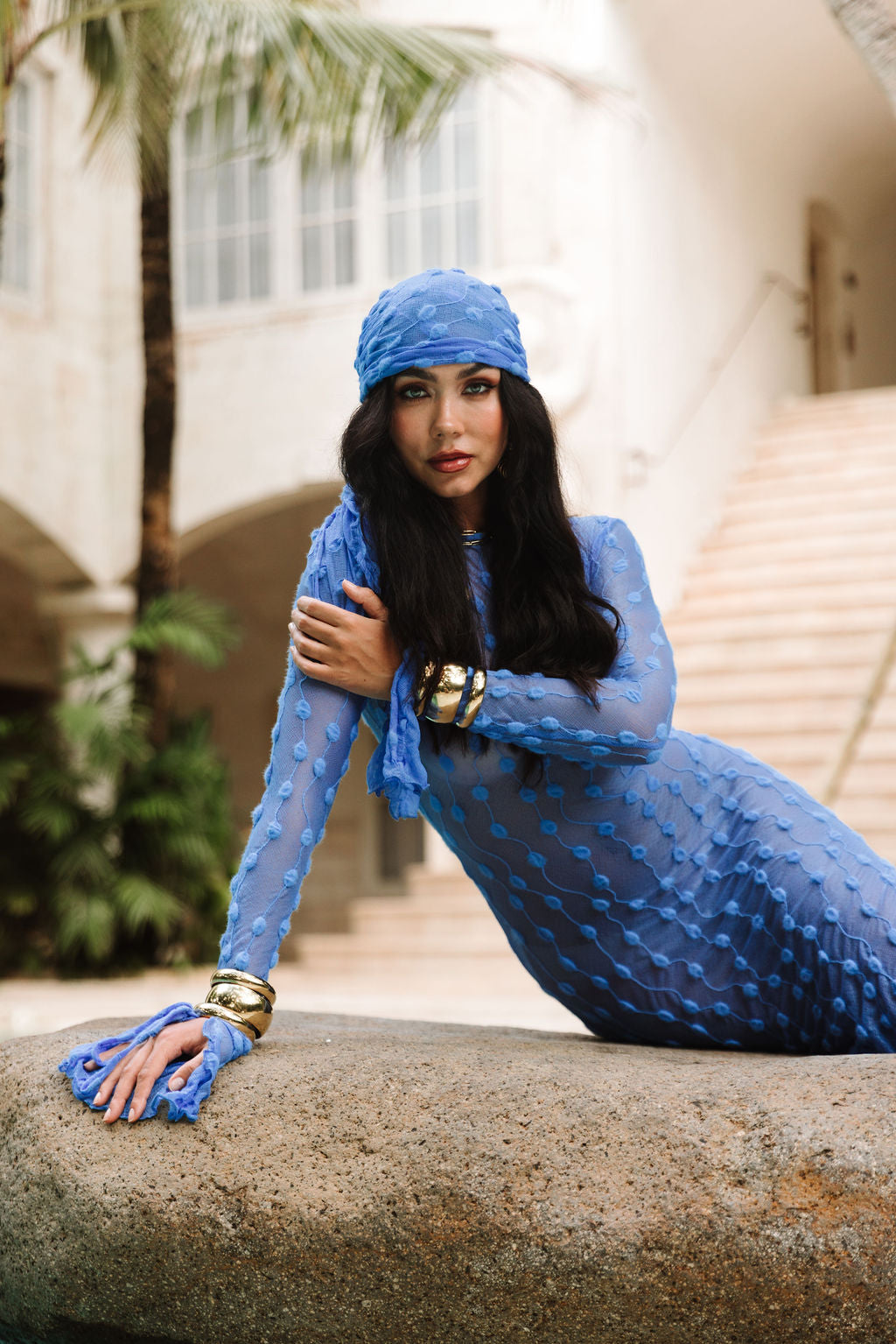 The Capri Dress in Amalfi Blue, on a courtyard step.